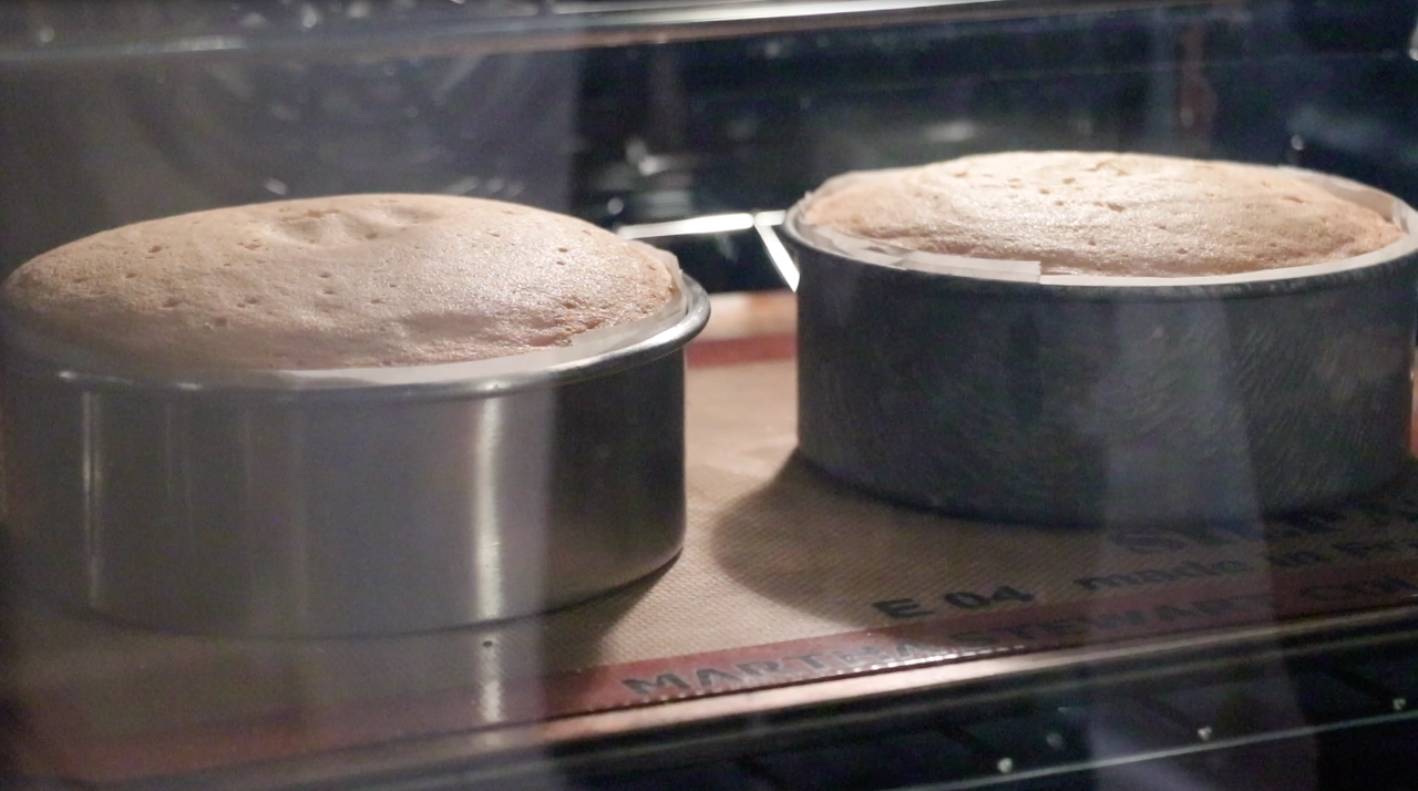 2 genoise sponge cake in the oven right before it's done