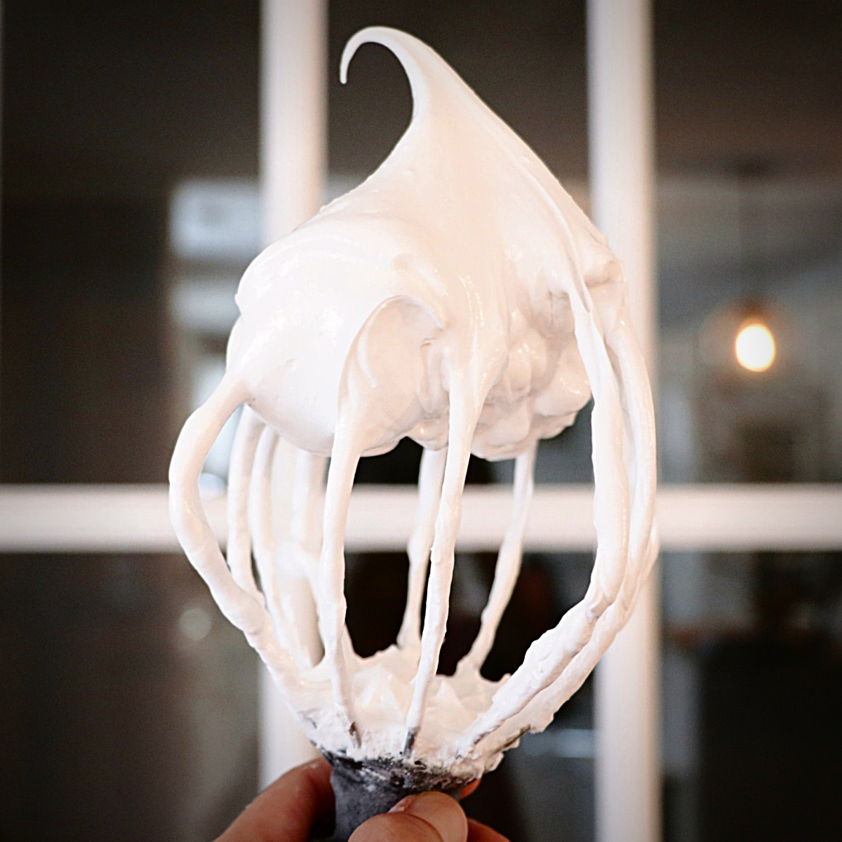 up-close of Italian meringue on a whisk
