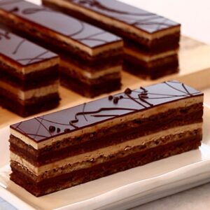 one slice of a classic opera cake on a plate