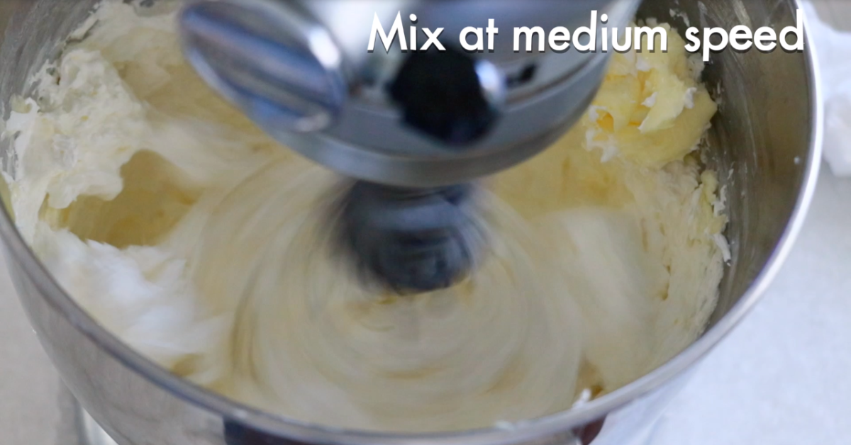 whipping soft butter and Swiss meringue in a bowl