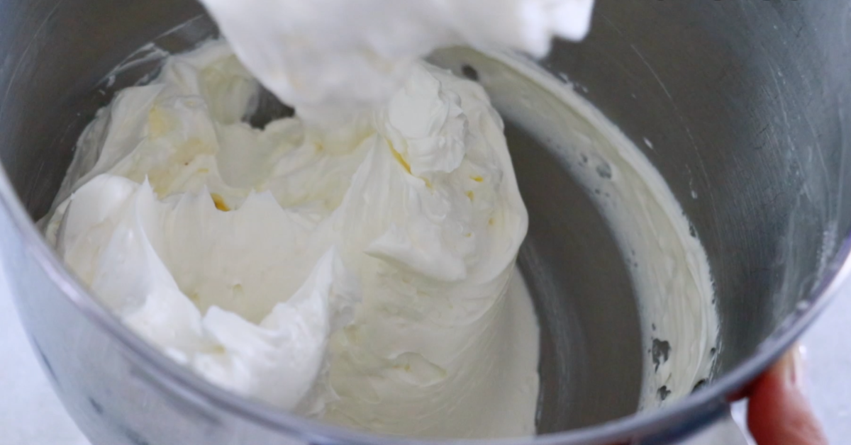 cleaning Swiss buttercream in a bowl