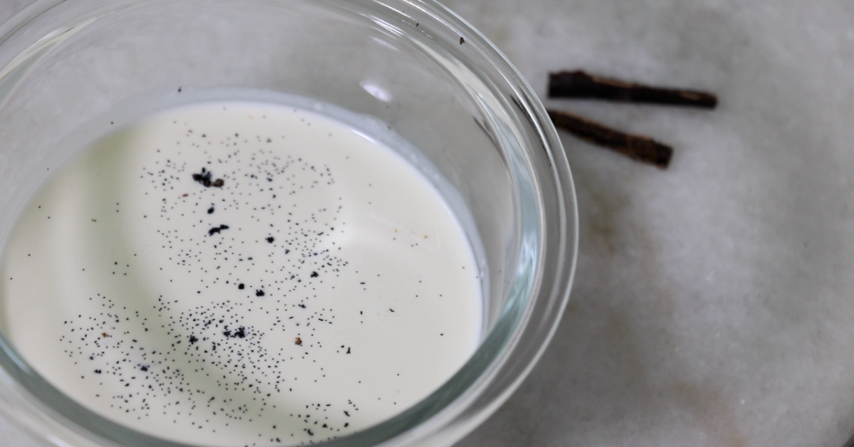 vanilla beans and heavy cream in a bowl