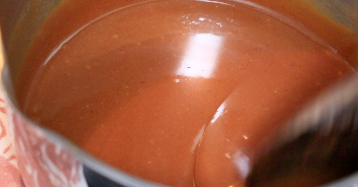 up-close of silky caramel sauce in a pod