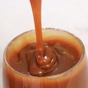 caramel sauce dripping in a glass
