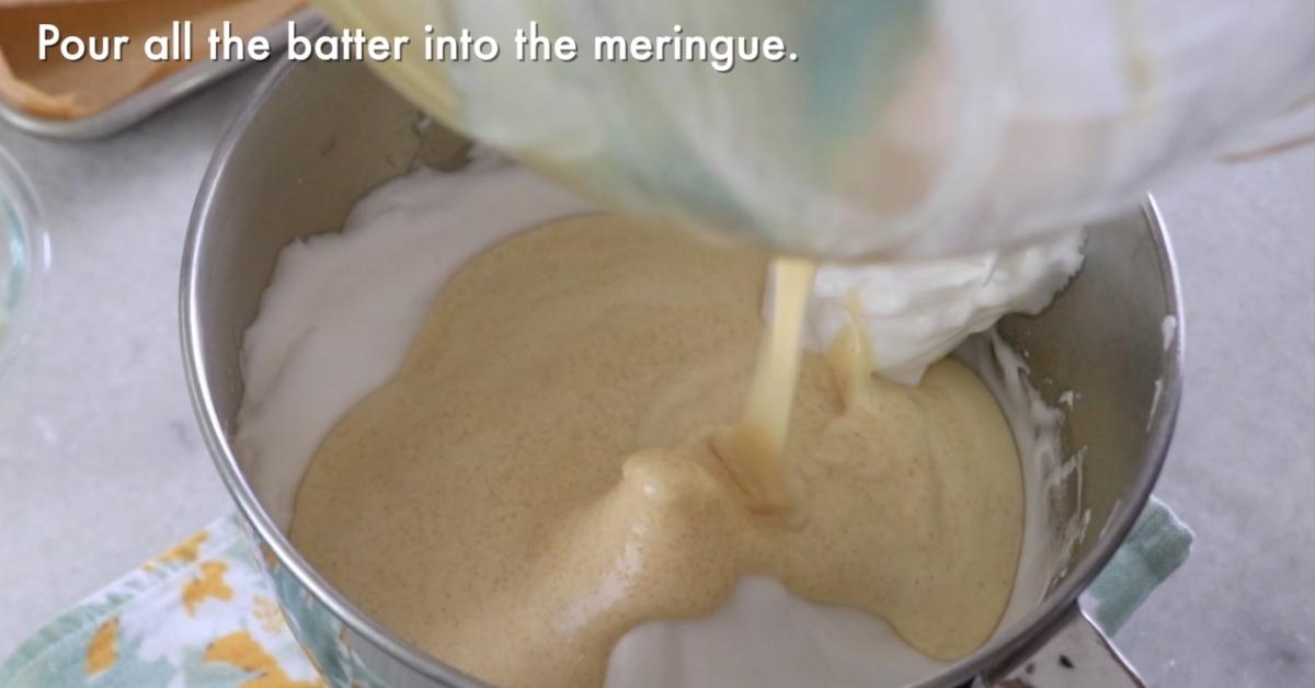 pouring the whole egg mixture into the meringue to make biscuit sponge