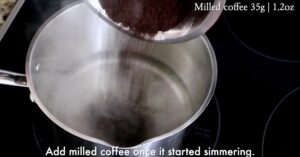 adding milled coffee in syrup