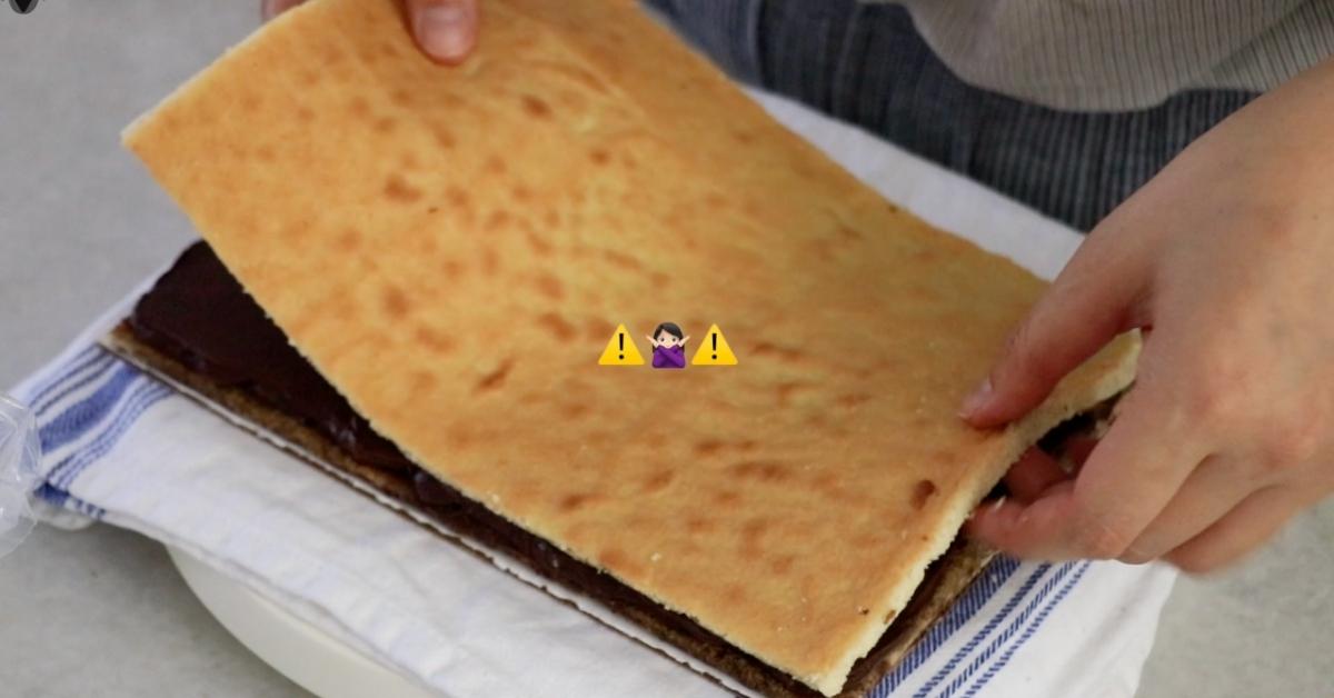placing a biscuit joconde on ganache layer