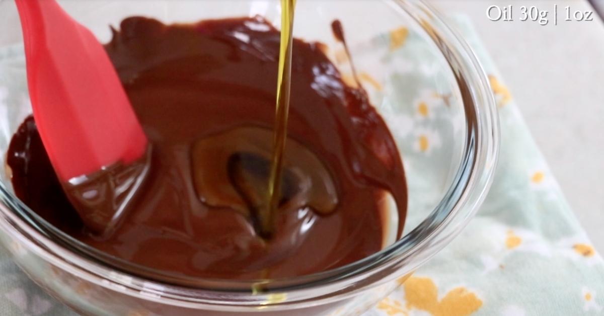 adding oil in melted chocolate