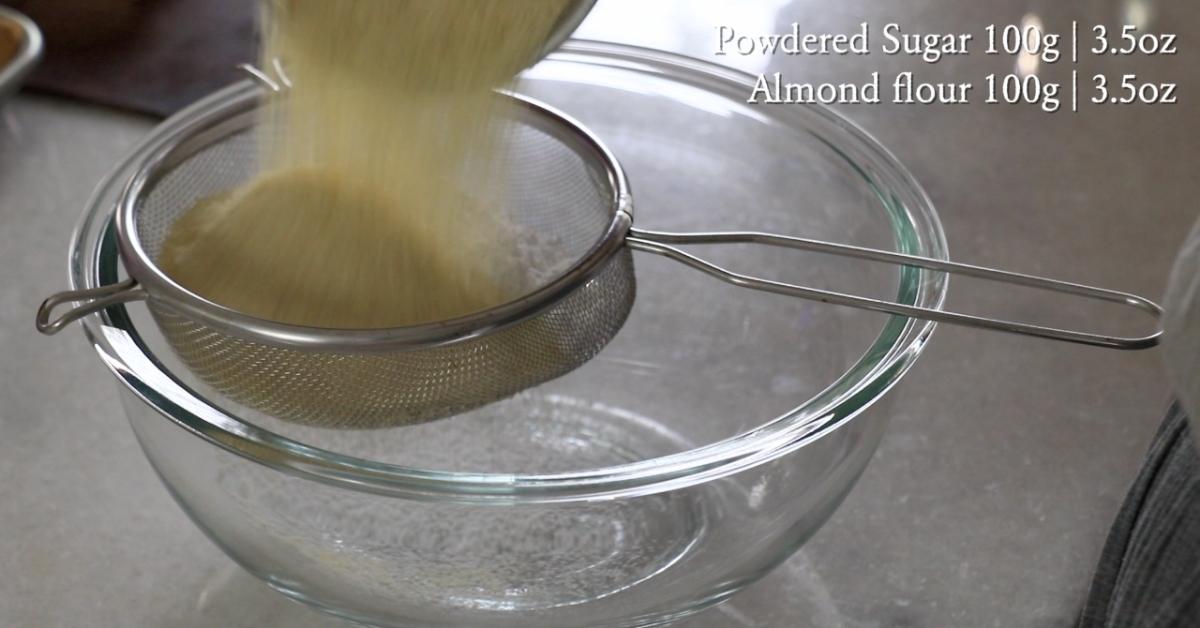 sifting powdered sugar and almond flour