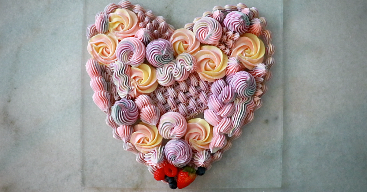 A multi-color buttercream heart with many kinds of piping techniques