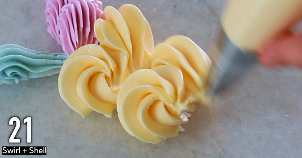 Orange buttercream decorations: small swirls and shells