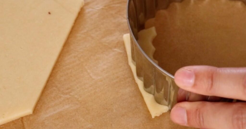 cutting the dough to make the edge of pecan pie cookies