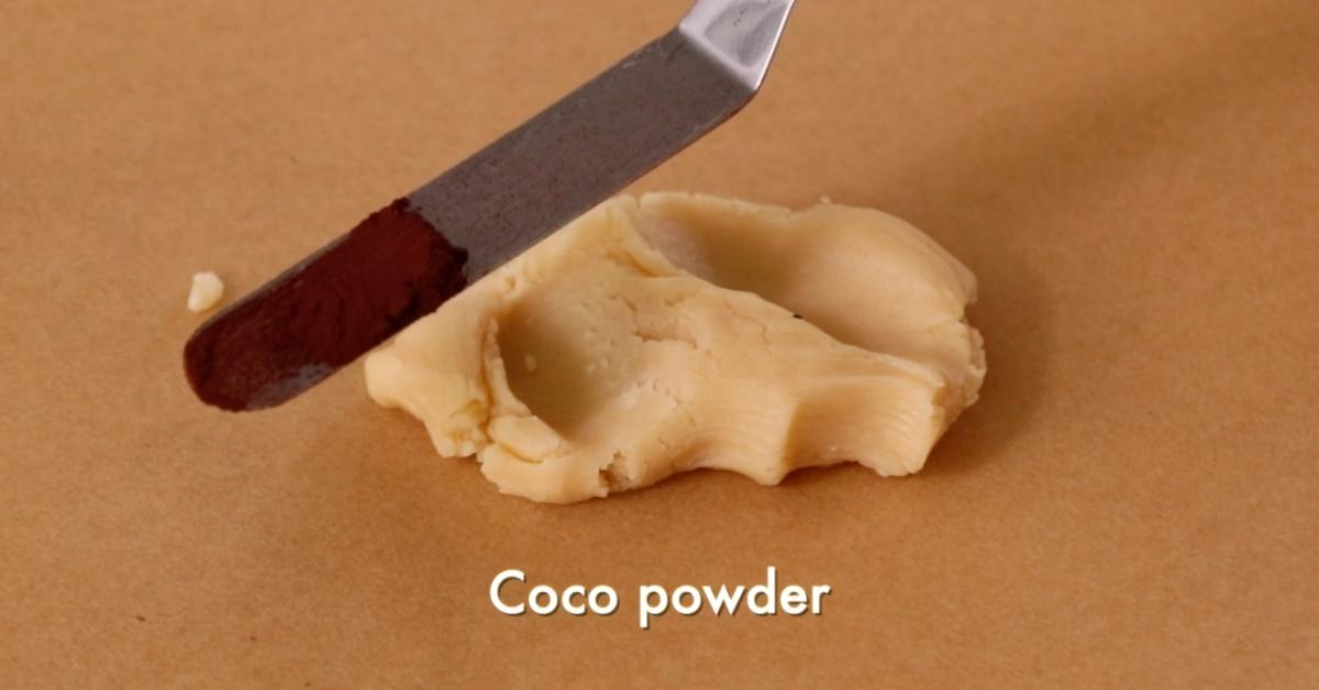 adding coco powder on plain dough