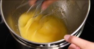 heating egg and sugar in a water bath