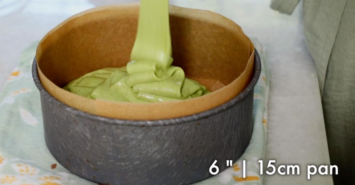 pouring green tea sponge batter in a 6" pan