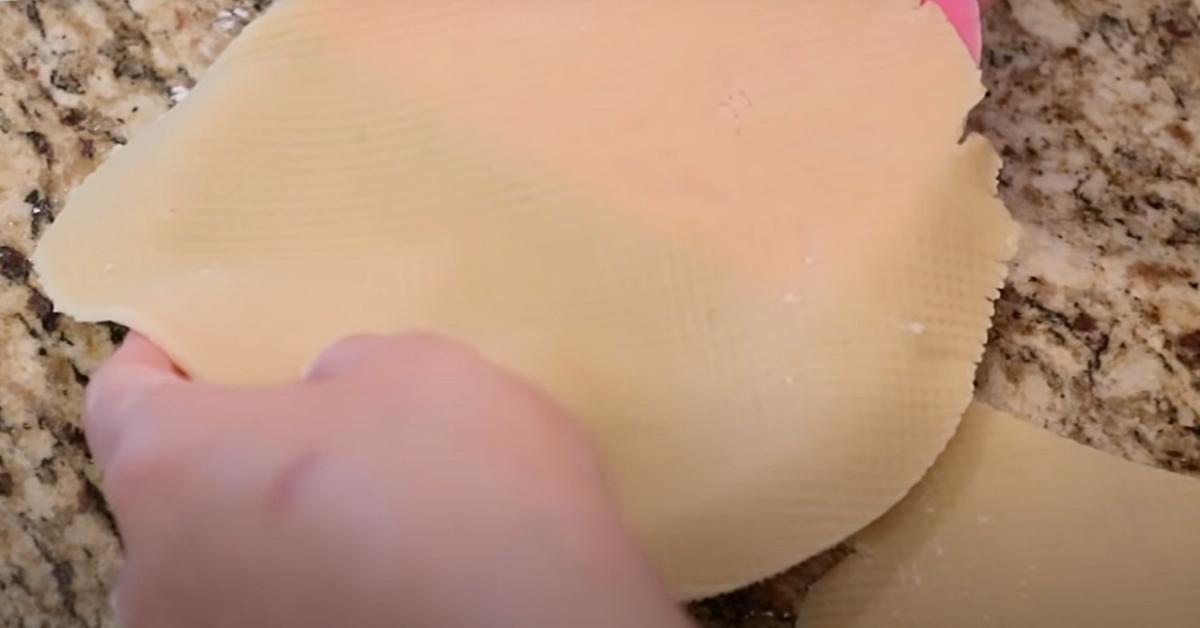 placing tart dough on top of a tart tin