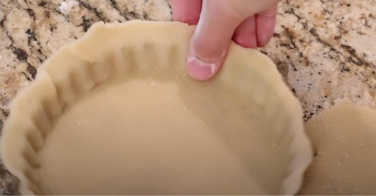 pushing the side of tart dough to set it in tart tin