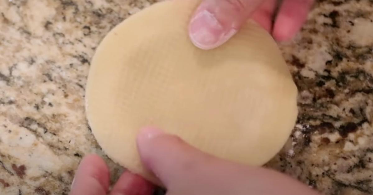 placing tart dough on top of a tartlet ring