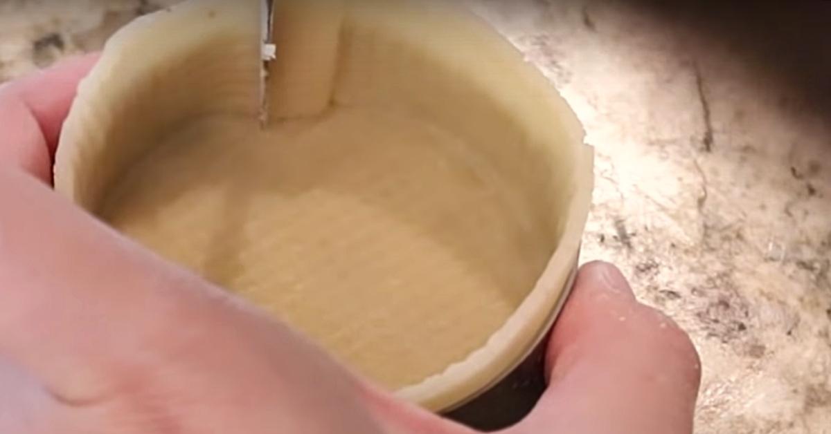 cutting the excess tart dough in a tartlet perforated ring