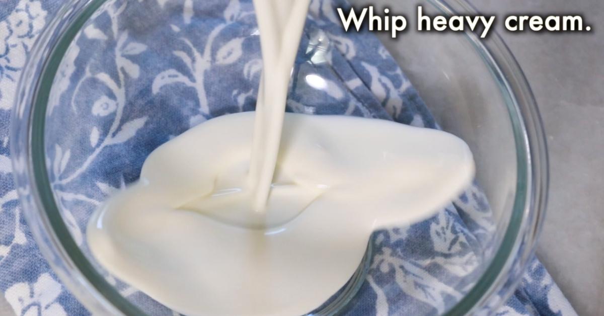 pouring heavy cream in a bowl
