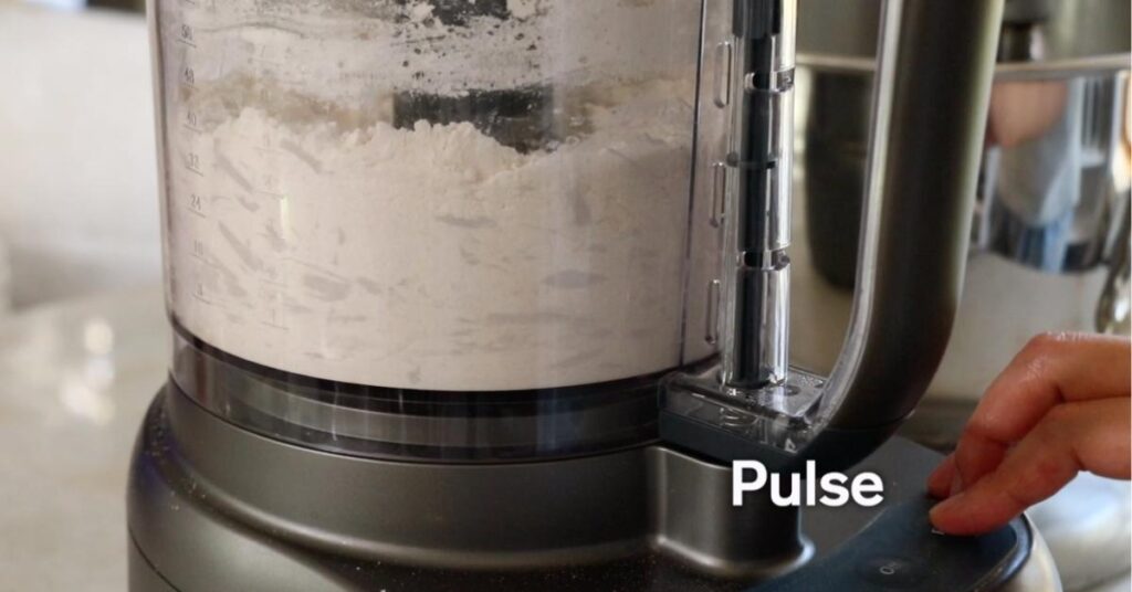 pulsing butter, flour, sugar and salt in a food processor
