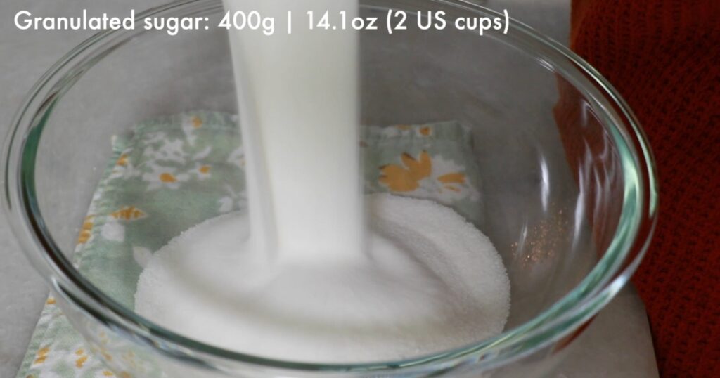 adding granulated sugar to a bowl