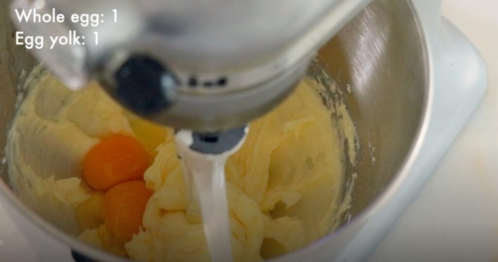 adding eggs in butter to make cookie dough