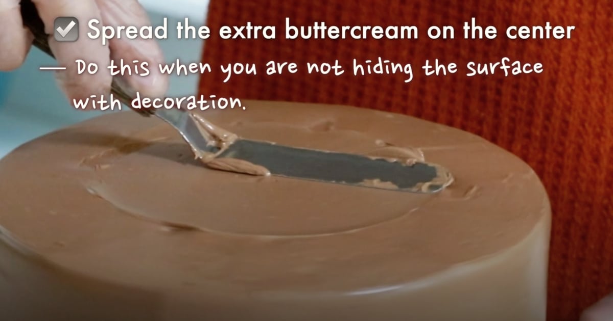 smoothing the surface of a frosted cake