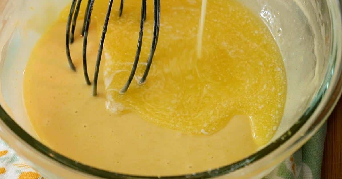 adding butter to the batter to make madeleines