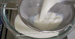 straining homemade milk syrup in a bowl
