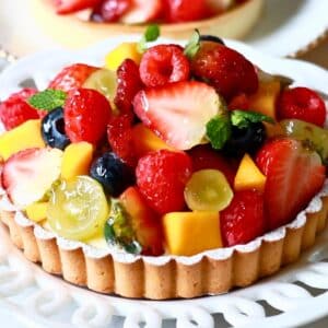 round fruit tart with lots of fruits on top