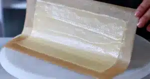 tuile batter spread into a rectangle shape on parchment paper
