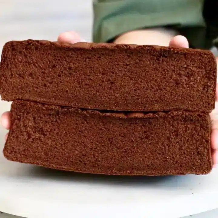 very fluffy chocolate sponge cake held by hand