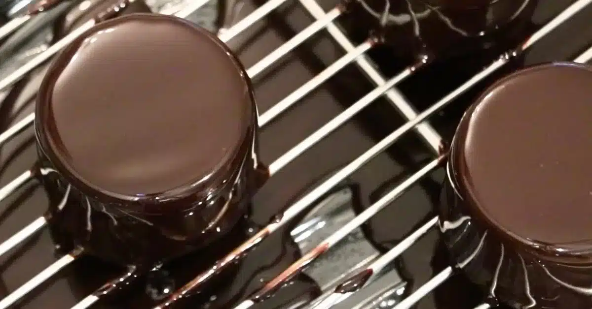 coated chocolate mirror glaze on a small cake