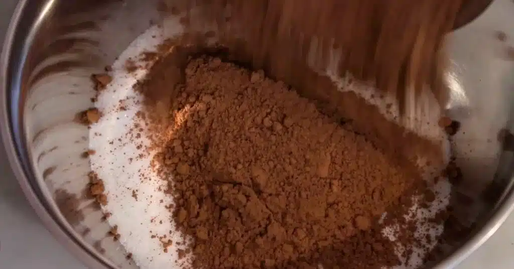 adding cocoa powder in sugar