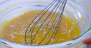 adding melted butter in egg, sugar, salt and all-purpose flour to make crepes