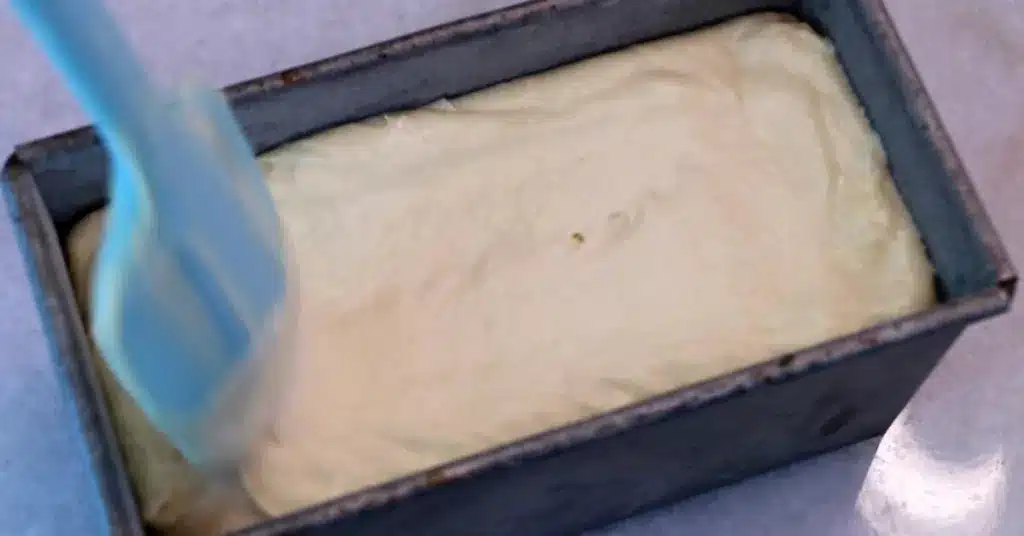 flattening the surface of lemon pound cake batter