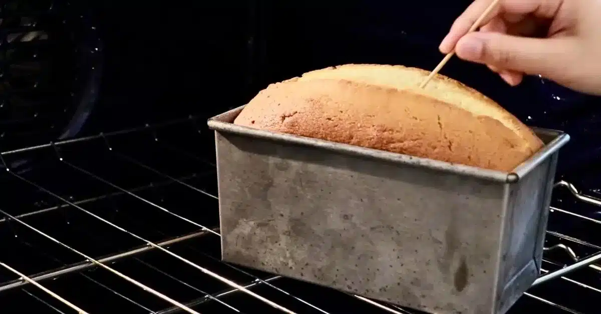 inserting a toothpick to check if the lemon pound cake is baked