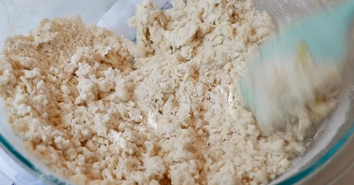 mixing flours and liquids to make pie dough