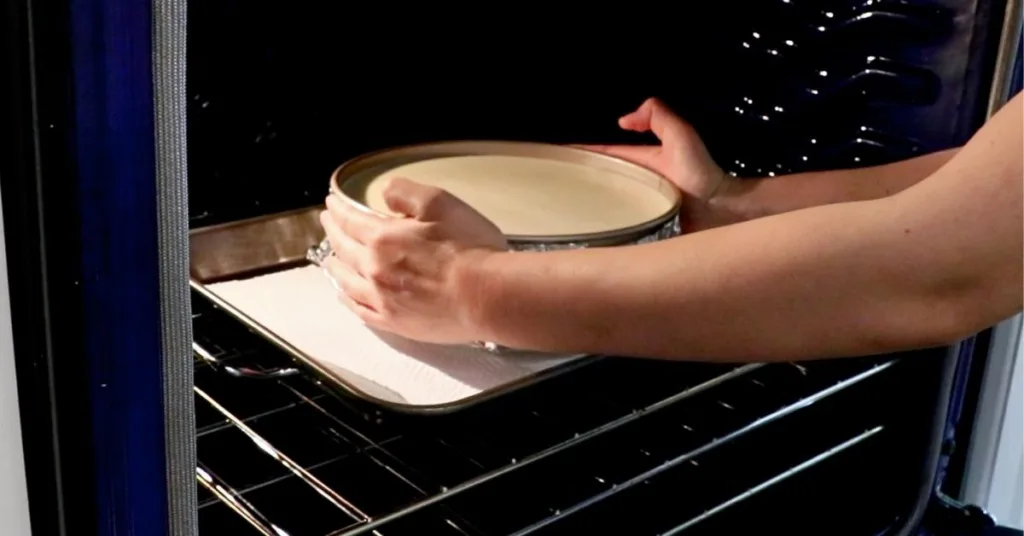 placing a cheesecake pan in the oven