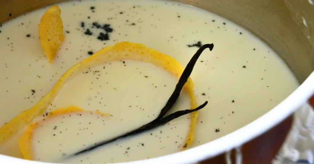 milk, lemon peel, and vanilla beans in a pot