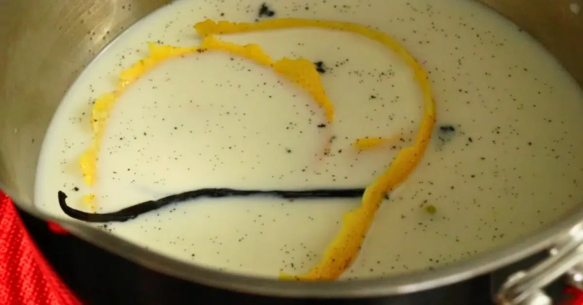 heating milk, lemon peel, and vanilla beans in a pot