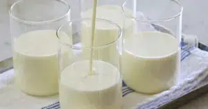 pouring vanilla panna cotta in glasses