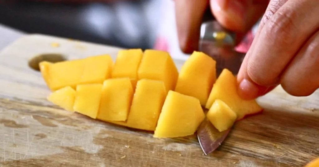 removing a skin of fresh mangos