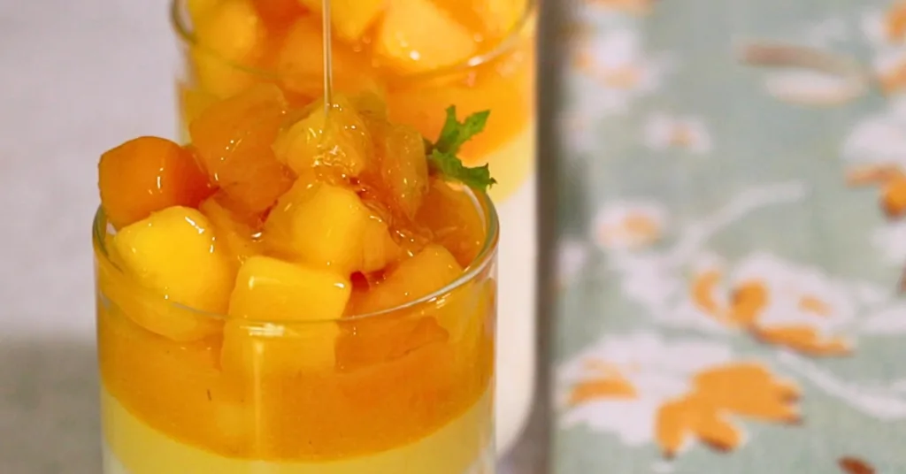 drizzling honey on mango panna cotta topping with mango panna cotta