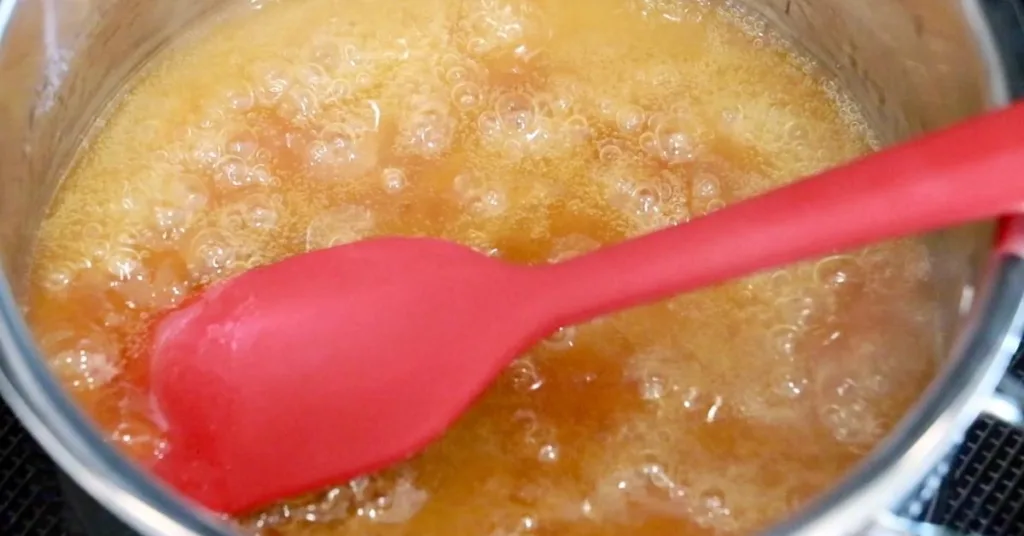 heated apricot jam, water, and lemon juice in a pot.