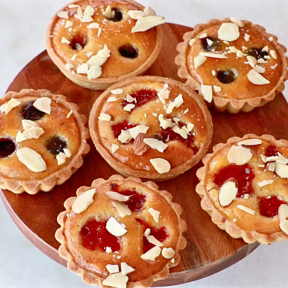 small almond tartlets with raspberries and blueberries