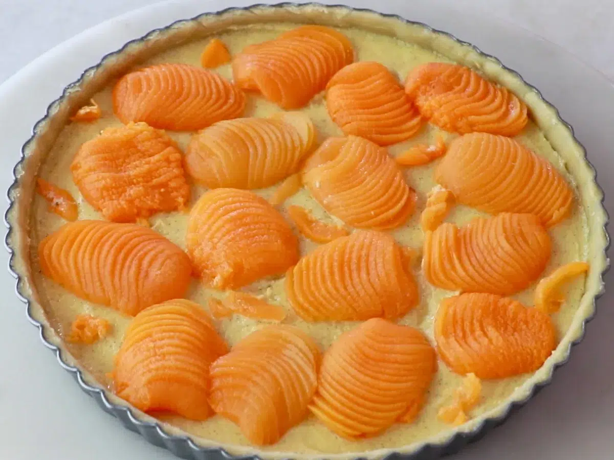 a whole almond apricot tart before baking