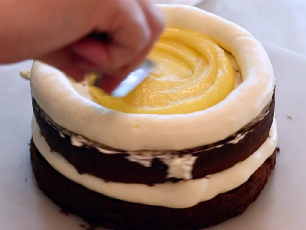 spreading lemon curd inside the cake