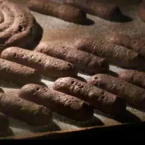 chocolate ladyfingers rising in the oven